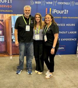 Laurel Johnstone with iPourIt team members at the iPourIt tradeshow booth.