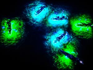 GlowRow kayaks putting out 20,000 lumens of light to see thru any type of water. A over head view showing a spectacular moment where you can see the clear kayaks, the lights, and what lies beneath.