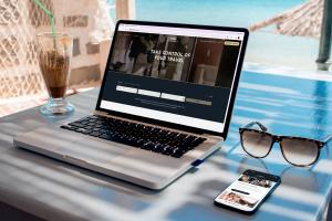 FlightpathAir.com displayed on a laptop and smartphone in a tropical setting.