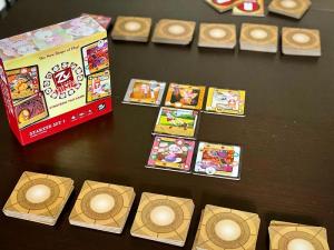 The image is a staged photo of Zu tiles Hime being played. various tiles are laid out in a typical depiction of the game