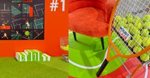 Court Clash event area featuring tennis-themed displays, tennis balls, a racket, podium, and colorful court décor.