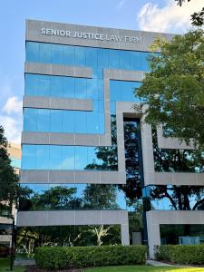Exterior of Senior Justice Law Firm Tower in Boca Raton, Florida, featuring Senior Justice Law Firm signage prominently displayed at the top of the building.