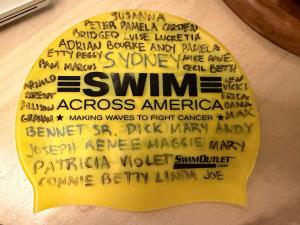 Marathon swimmer Maya Merhige writes the names of those fighting cancer or those who have been lost to the disease on her swim cap before her marathon swims. She swims to raise funds for cancer research with Swim Across America.