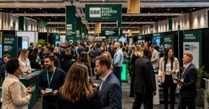 Image of crowded Small Business Expo exhibitor hall with entrepreneurs and business professionals networking among exhibitor booths.