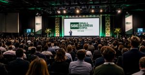 Packed Small Business Expo keynote presentation with a large audience of entrepreneurs and business professionals.