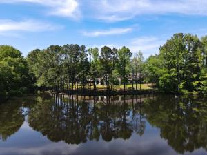 exterior view of facility behind the trees on a lake