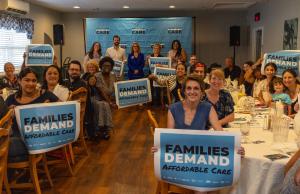 At a community conversation in Scranton, Pennsylvania, attendees hold signs that read "Families Demand Affordable Care."