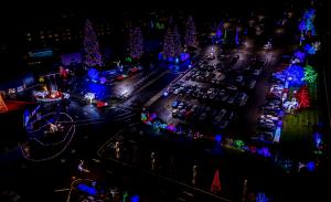 Aerial view of Seven Feathers Casino Resort's parking lot lined with brightly lit Christmas trees, part of Christmas Decor's holiday lighting installation.