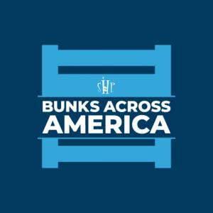 The Bunks Across America logo featuring a light blue illustrated bunk bed frame on a dark navy background, with the SHP monogram and the bold white text "Bunks Across America."