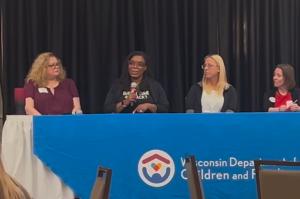 Natasha Broxton speaking into a microphone on a Wisconsin Department of Children and Families relative caregiver panel.