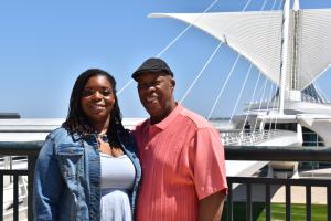 Natasha Broxton standing outdoors with an adult family member.