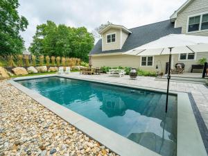 Backyard gunite pool with paver patio and boulder landscaping