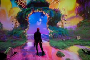 A woman standing in a digital world at Artechouse