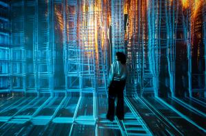 A woman standing in Artechouse with a digital display