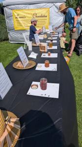 Honey tasting table at the Oregon Honey & Mead Festival with jars of Oregon honey prepared for sampling and judging.