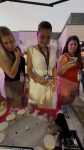 Guests watching their photos get printed onto a cookie at our cookie printing activation