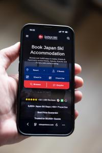 The Japan Ski Experience platform on mobile, with accommodation search and instant booking across Japan's leading ski resorts.