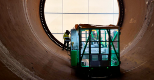 Magnet-mounted gantry milling machine  from CNC Onsite operating inside a large steel wind turbine transition piece.