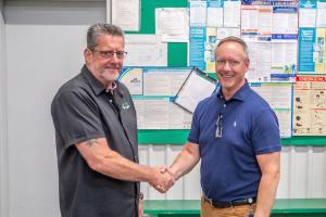 Jim Mugford and Rick Richardson shake hands after announcing new acquisition.