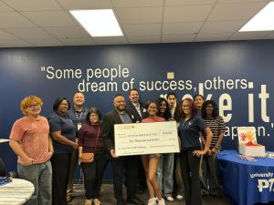 A group of UHS students celebrates their grant with an oversized check presented by the local McDonald’s leadership Michael King and Luis Bonilla of McDonald’s / Yontz Enterprises. Also pictured are UHS PTSA Past President Kanisha James and UHS Principal 