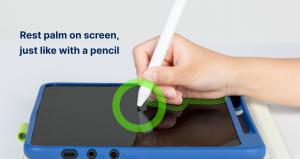 A child rests their palm on the tablet while writing.