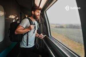 Solo male traveler looking outside a train window