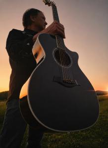 Claude Carmichael With Guitar (2026) [courtesy of Claude Carmichael]