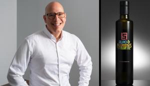 Michael Maloney, Chief Creative Officer of Brand Force 5, pictured alongside the Silvio & Filomena’s Olive Oil bottle designed by the agency.