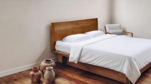 White bamboo lyocell bedding on a wooden bed in a minimalist bedroom