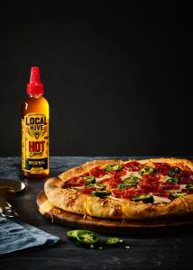 Local Hive™ Original raw & unfiltered Hot Honey drizzled on pizza