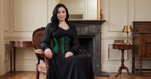 LUXE NOIR™ Ivy green brocade underbust waist training corset with black panels and steel busk, styled over a black dress.