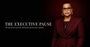 Marki Lemons Ryhal stands in an oxblood double-breasted suit against a black and deep-red background, wearing black smart glasses and an AI voice recorder. White text reads, “The Executive Pause” and “The law protects your job. Automation protects your ca