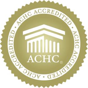 The golden logo of the ACHC, signifying that Everest Surgery Center has officially received accreditation through the organization.