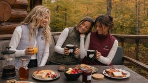 Three women wearing heated apparel outdoors in fall