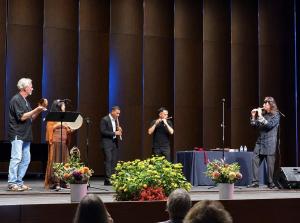 Taiwanese flutist Lin Hsiao-Feng performing onstage with international flutists at the 2026 World Flute Society Annual Convention.