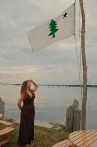 Kate the Earthling salutes the Maine flag at Harpswell Collective
