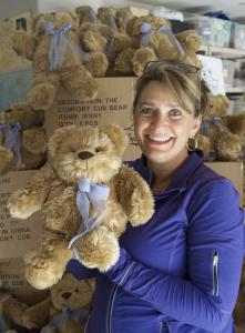 Marcella Johnson, founder of The Comfort Cub, nonprofit, holding a weighted therapeutic Comfort Cub.