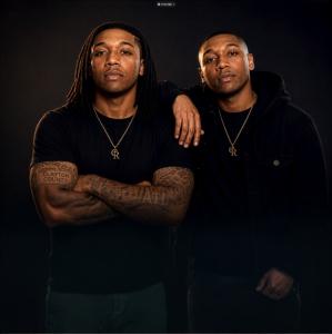 Two members of Southern hip-hop duo C. Rano posed together against a dark studio background.