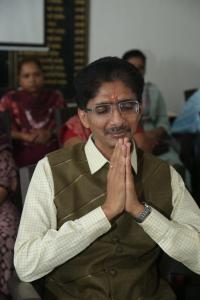 Hiten Bhuta seated at the AI 2055 Training Program at PM Shri Damanagar School No. 2, with his hands folded in greeting.