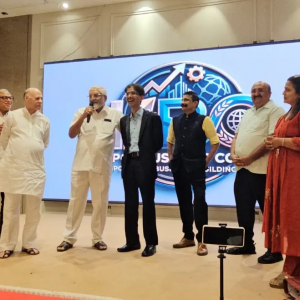 Hiten Bhuta speaking on stage during the AI Agents & AI – 2055 program in Mumbai with Kapol entrepreneurs and community representatives.