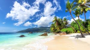 Granitic rock formations, turquoise shallow water, and lush tropical vegetation await you in the Seychelles.