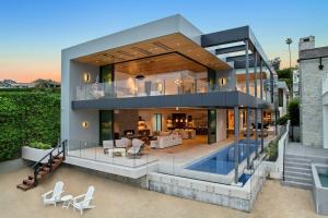 An aerial view of 2201 Bayside Drive, a waterfront residence in Corona del Mar with a private dock on Newport Harbor.