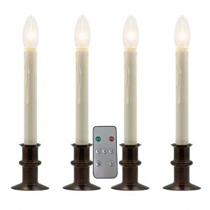 Four Celestial At Home Window Hugger window candles with antique bronze flat-back bases and ivory wax-drip sleeves, shown with the remote and its 6, 8 and 12 hour timer buttons