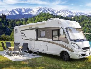 An RV campsite setup illustrates the use of portable high-back folding chairs in travel-oriented outdoor settings where comfort and compact storage are important.