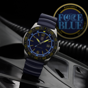 Luminox FORCE BLUE dive watch with a blue dial and strap, yellow markers and black dive bezel, displayed on diving equipment with the FORCE BLUE logo in the background.