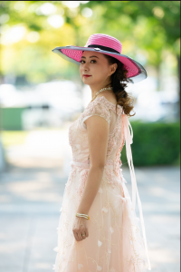Shekinah Grace Moyes in an elegant pink dress and sunhat, reflecting the joy, grace and hope found through faith in Jesus Christ.