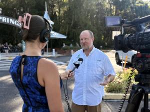 Florida State Parks Foundation Board President Matt Caldwell speaks with a reporter before the Foundation announced 25 new e-bikes for Florida State Parks rangers on Thursday, Aug. 27 at Silver Springs State Park in Ocala.