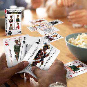 People playing KultureGames Black Legends cards featuring notable Black figures from around the world.