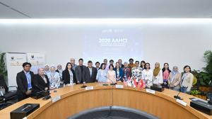 Large group photo of symposium panellists and delegates.