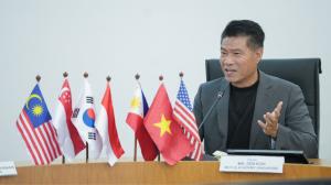 Zen Koh speaking at a podium